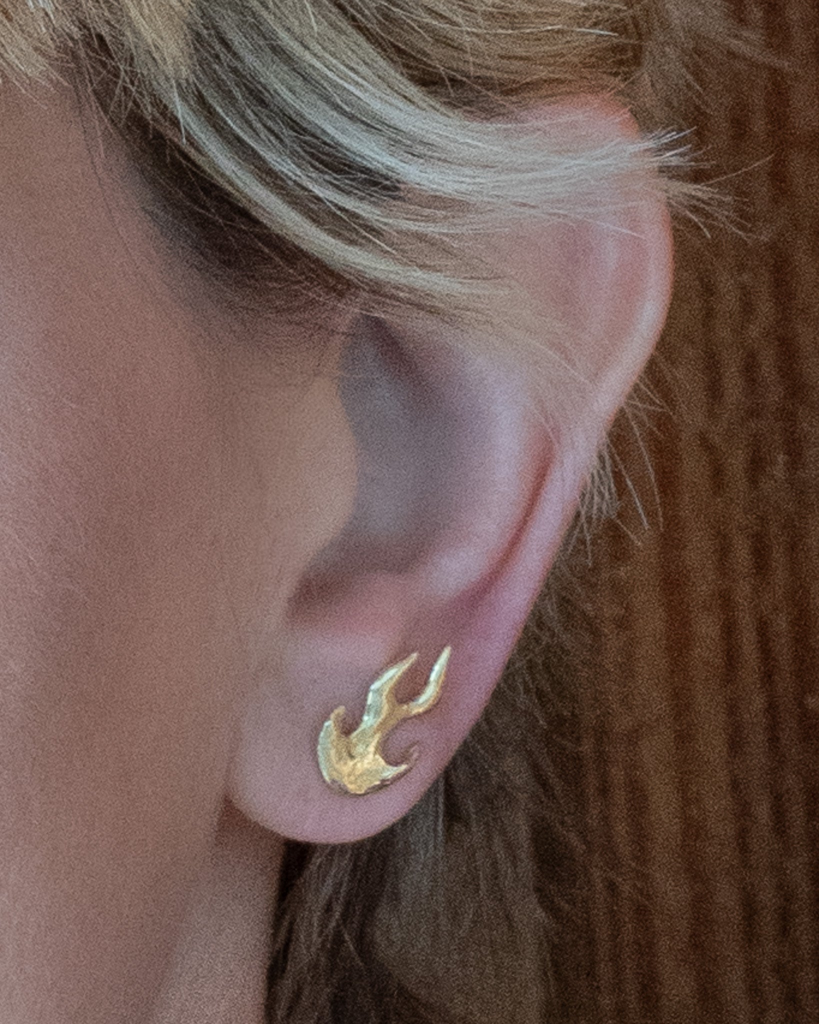 Firehorse Set – Flame Earring in bronze, close-up on ear — Zefiro Jewels