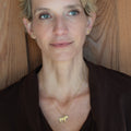 Firehorse Pendant in bronze worn by woman, lifestyle portrait — Zefiro Jewels
