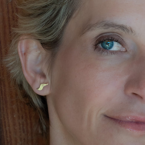 Flame Earrings in bronze, close-up side view on ear — Zefiro Jewels