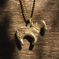 Firehorse Pendant in bronze with ball chain, close-up on wood — Zefiro Jewels